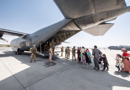 Evacuees board the Hercules aircraft at Hamid Karzai International Airport in Kabul