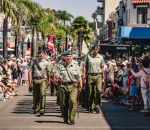 Army personnel march through the city of Napier with swords drawn, bayonets fixed, music playing and Colours flying.